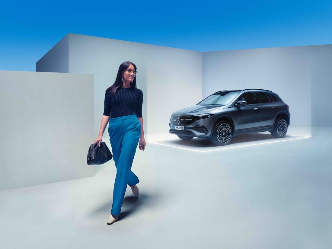 Una donna si allontana dalla sua Mercedes-Benz parcheggiata.