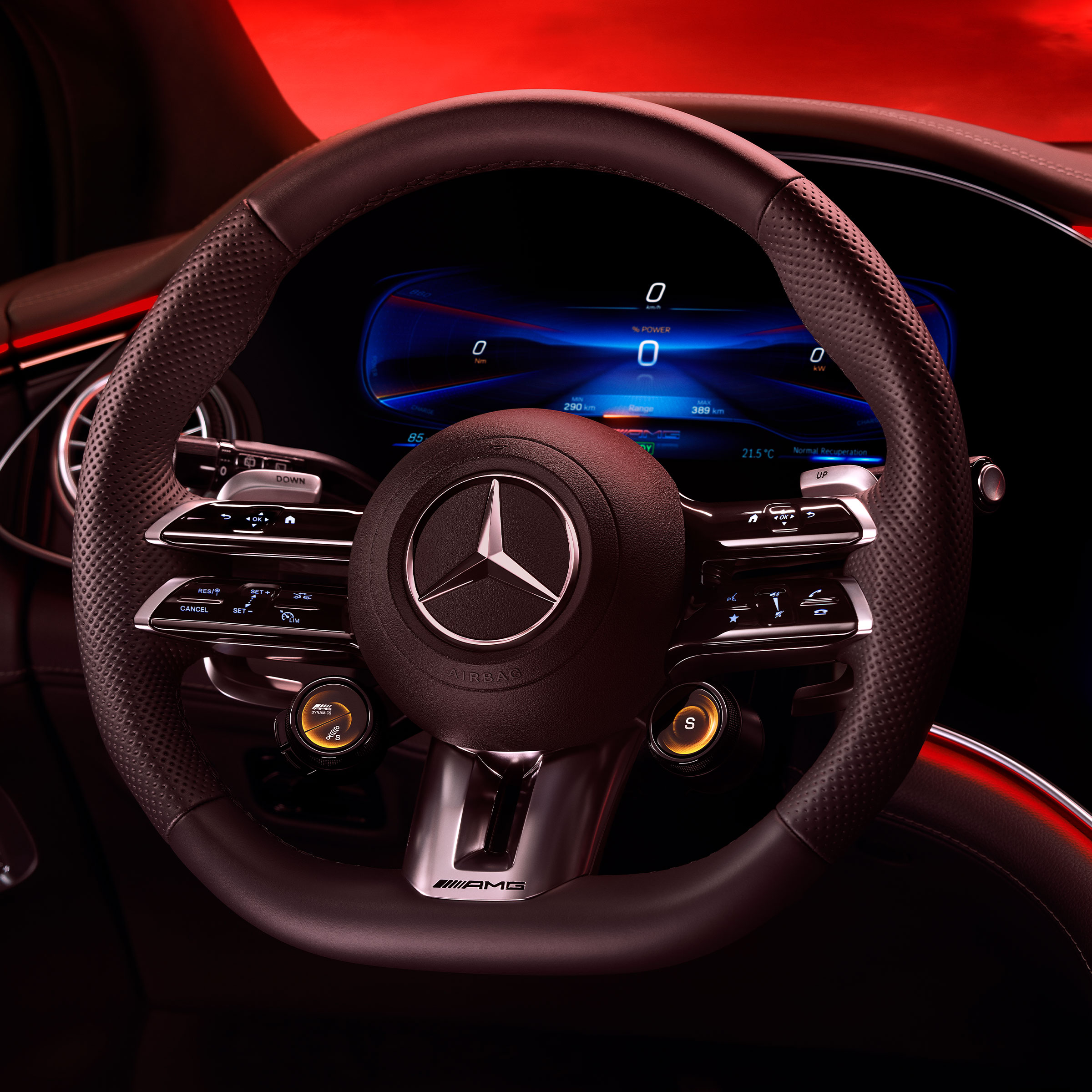 Vista del volante AMG Performance dal sedile lato guida con uno sfondo rosso.