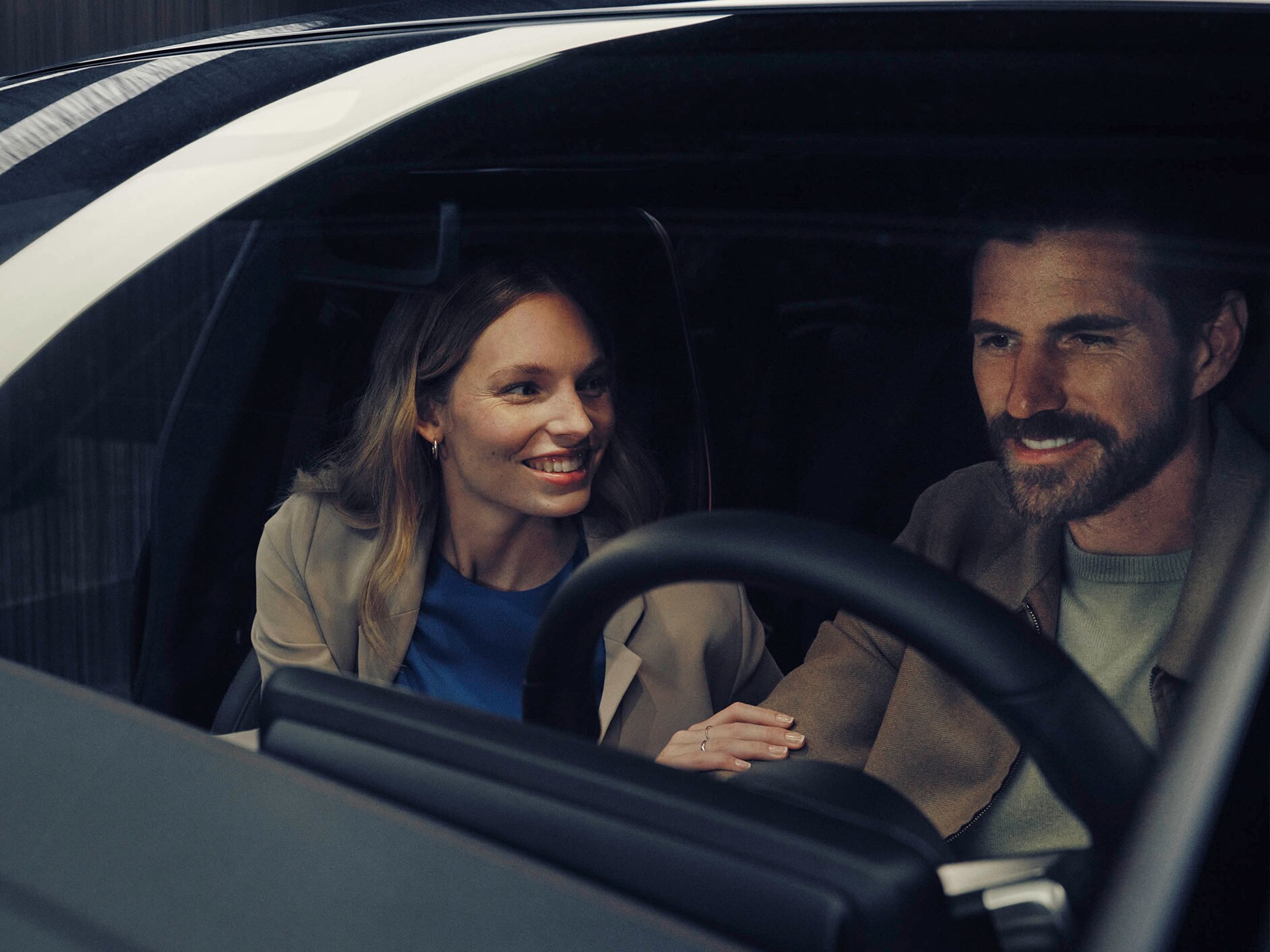 Man and woman sitting in Mercedes-Benz  EQS