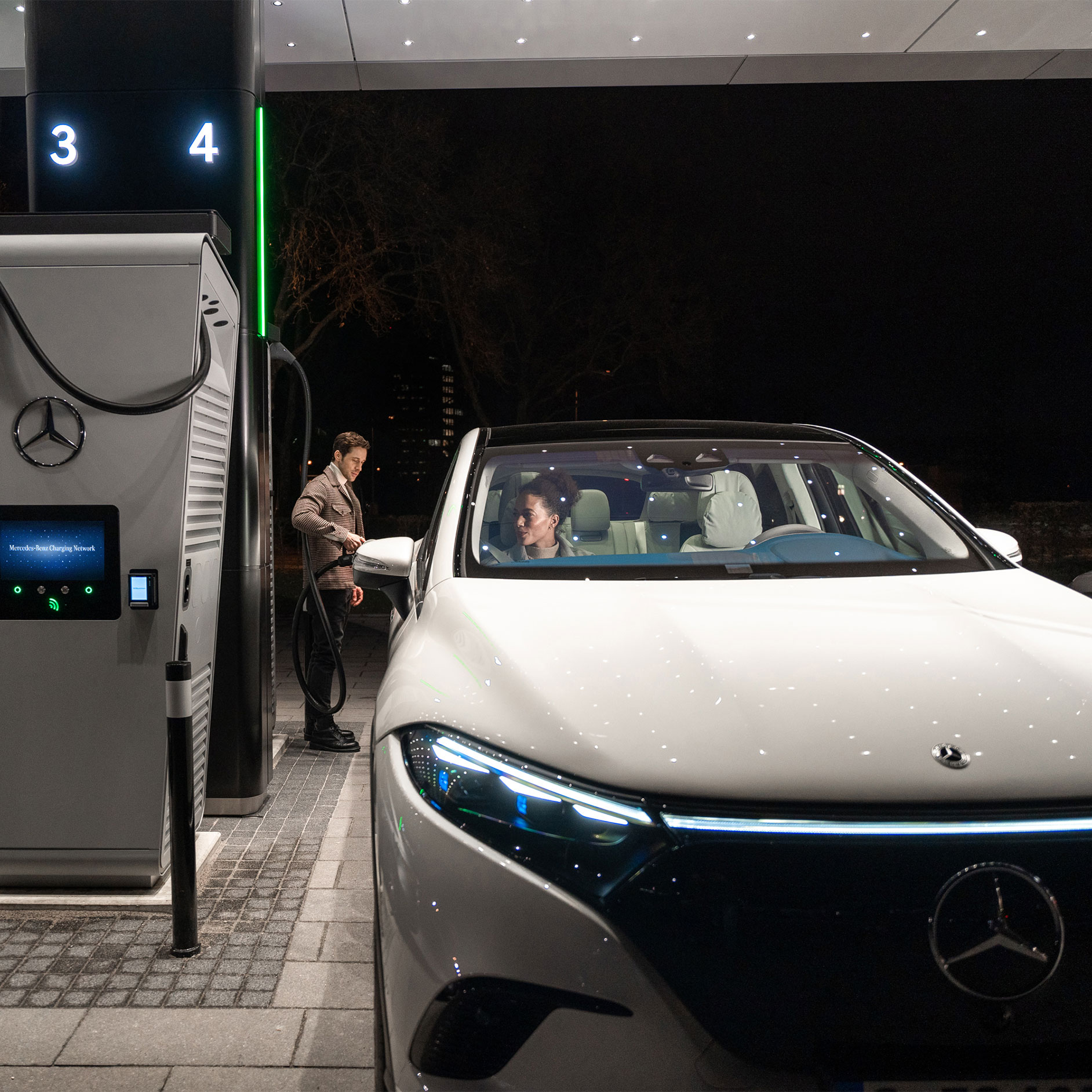 Soluzioni di ricarica | Tecnologia | Mercedes-Benz Mercedes-Benz CLA elettrica ferma su una strada e collegata a una stazione di ricarica.