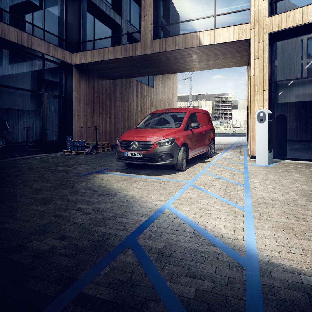 The Mercedes-Benz eCitan Panel Van is parked in front of a building. 