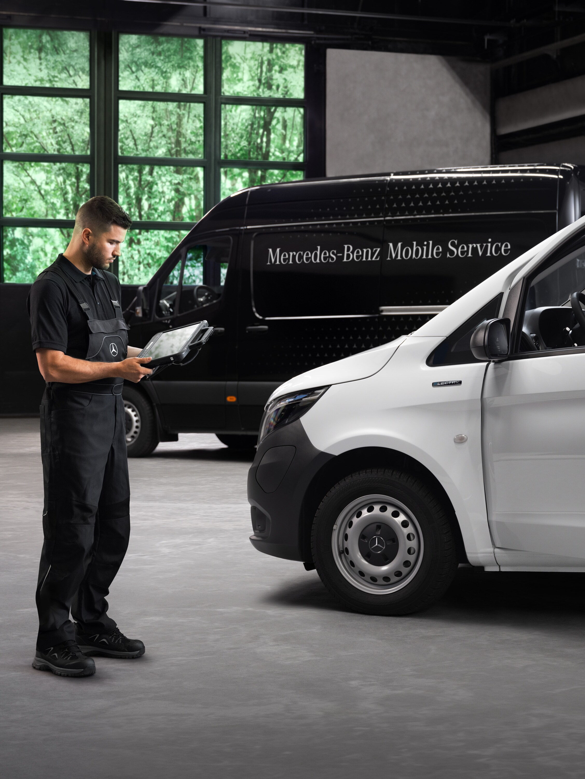 Un tecnico controlla un veicolo commerciale Mercedes-Benz Vito bianco in officina.