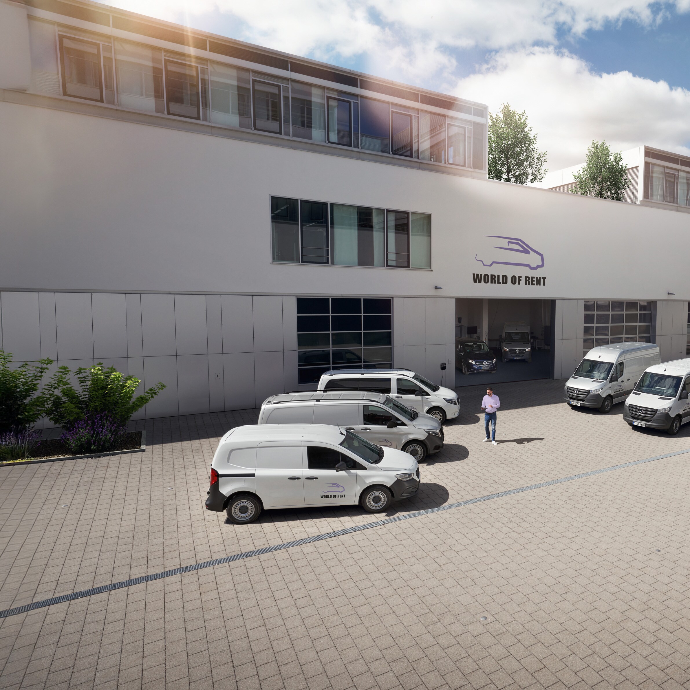 Alcuni veicoli commericali Mercedes-Benz davanti a un edificio
