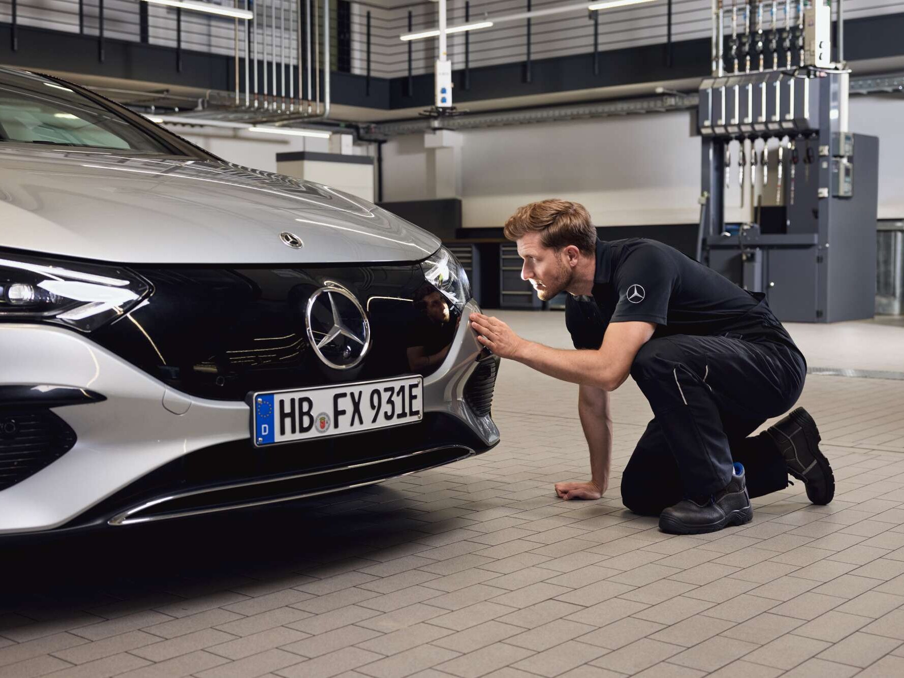 Meccanico seduto davanti a una vettura Mercedes-Benz